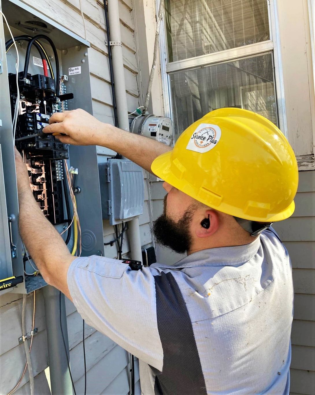 electrician working on fuse box