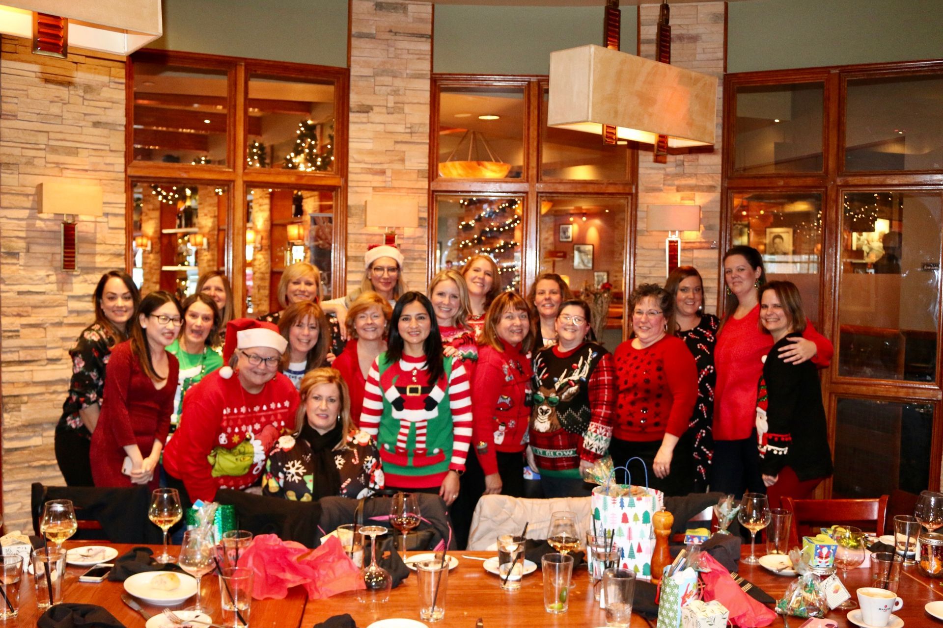 A group of people are posing for a picture at a christmas party.