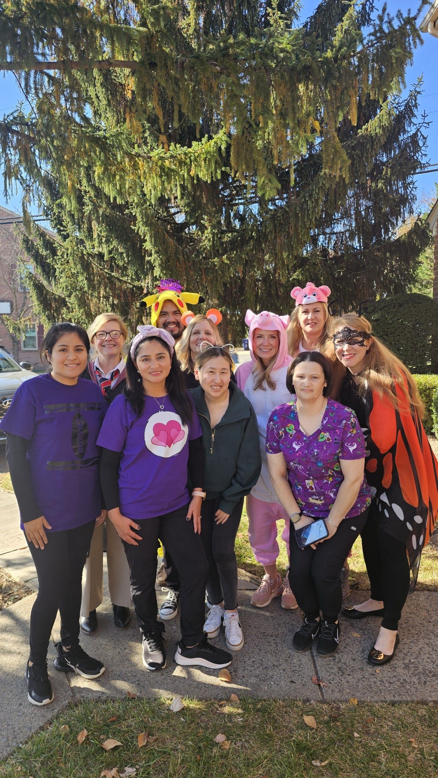 Employees of Town Pediatrics dressed in Halloween costumes outside their office. 