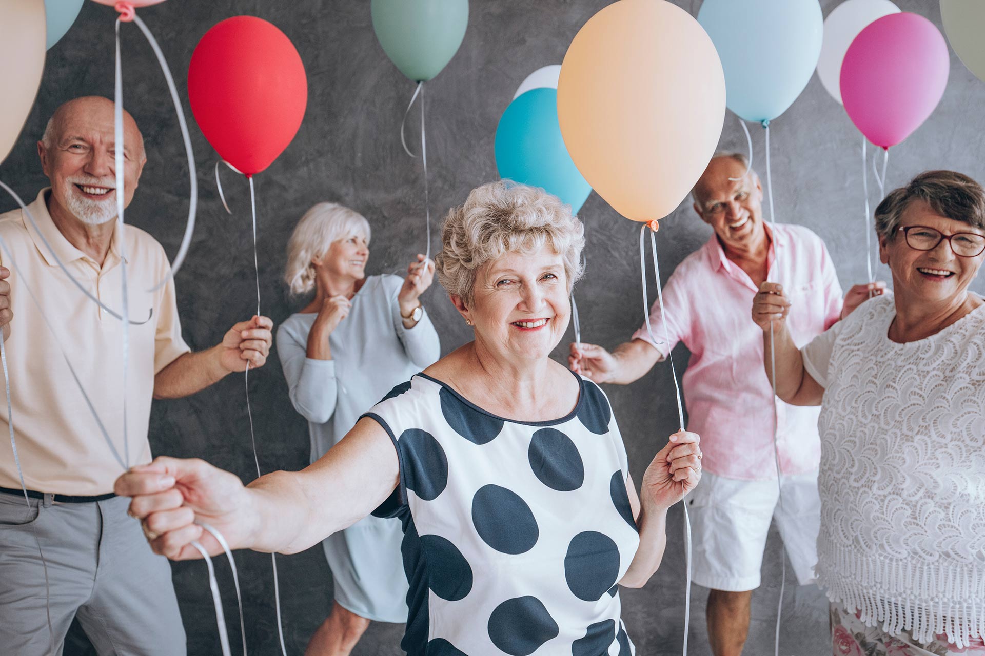 old people holding baloons