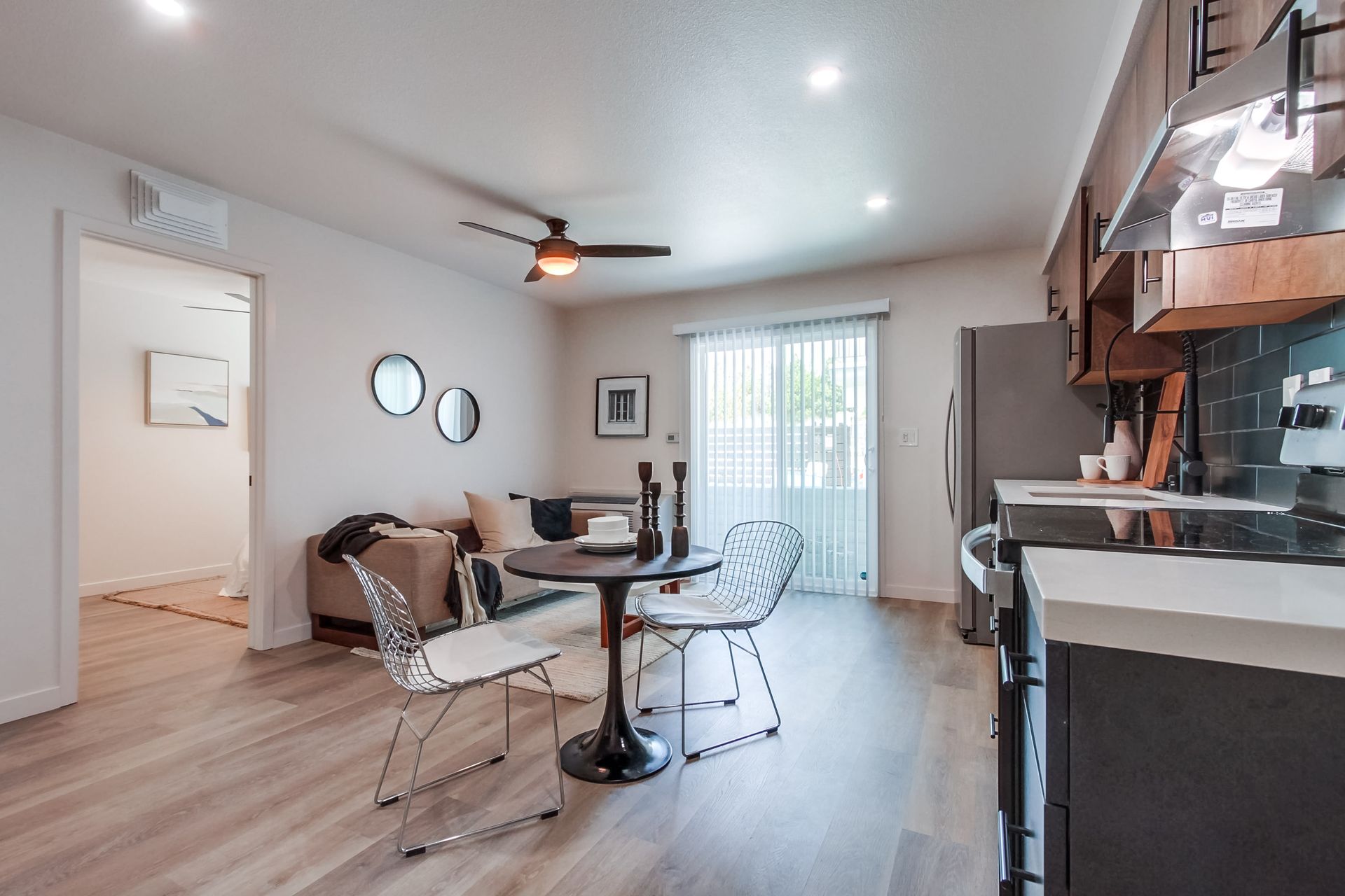 Photo showing a living area with sliding glass doors leading to a balcony