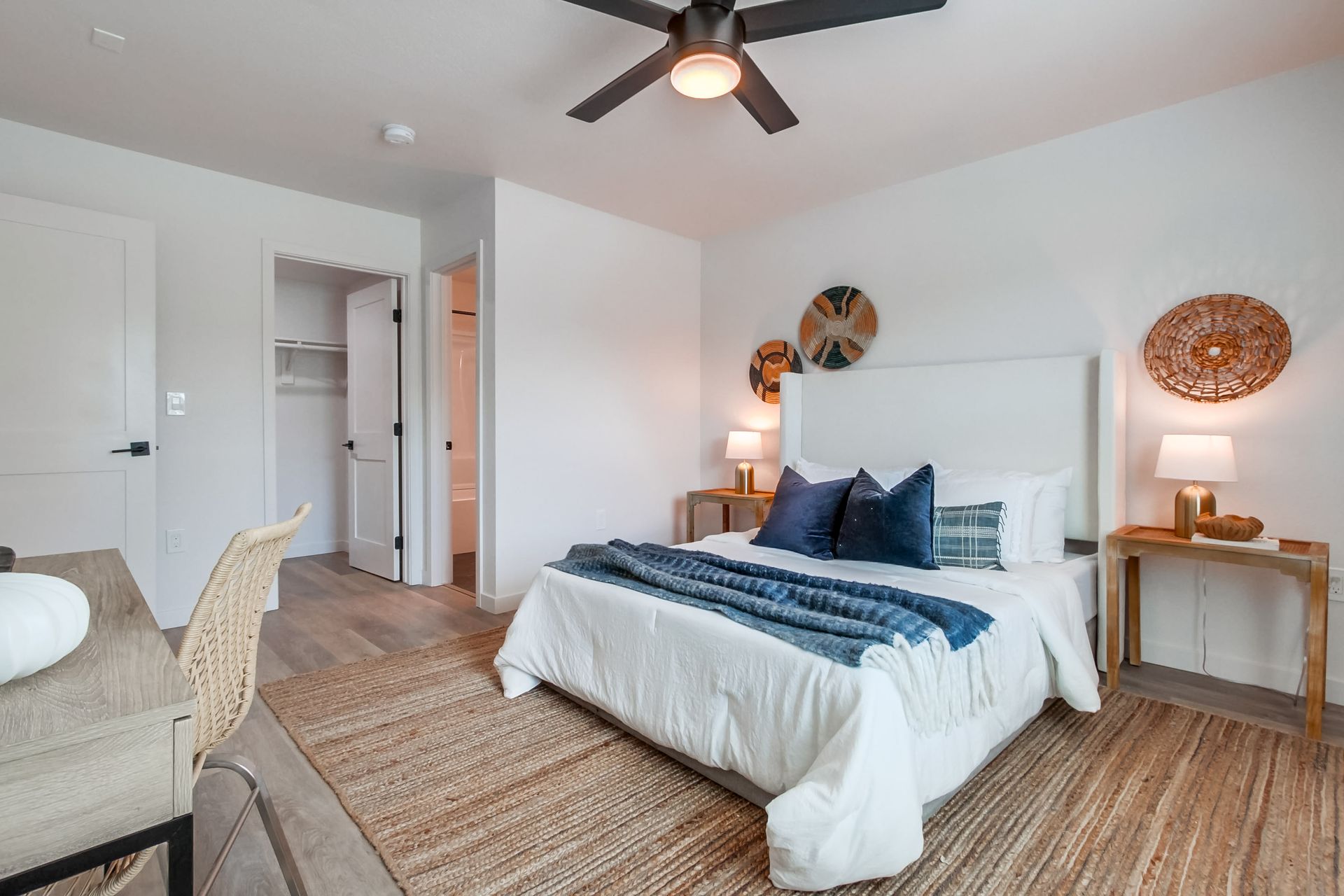 Photo showing a large bedroom big enough to fit a full-size bed, a desk and still have plenty of walking space