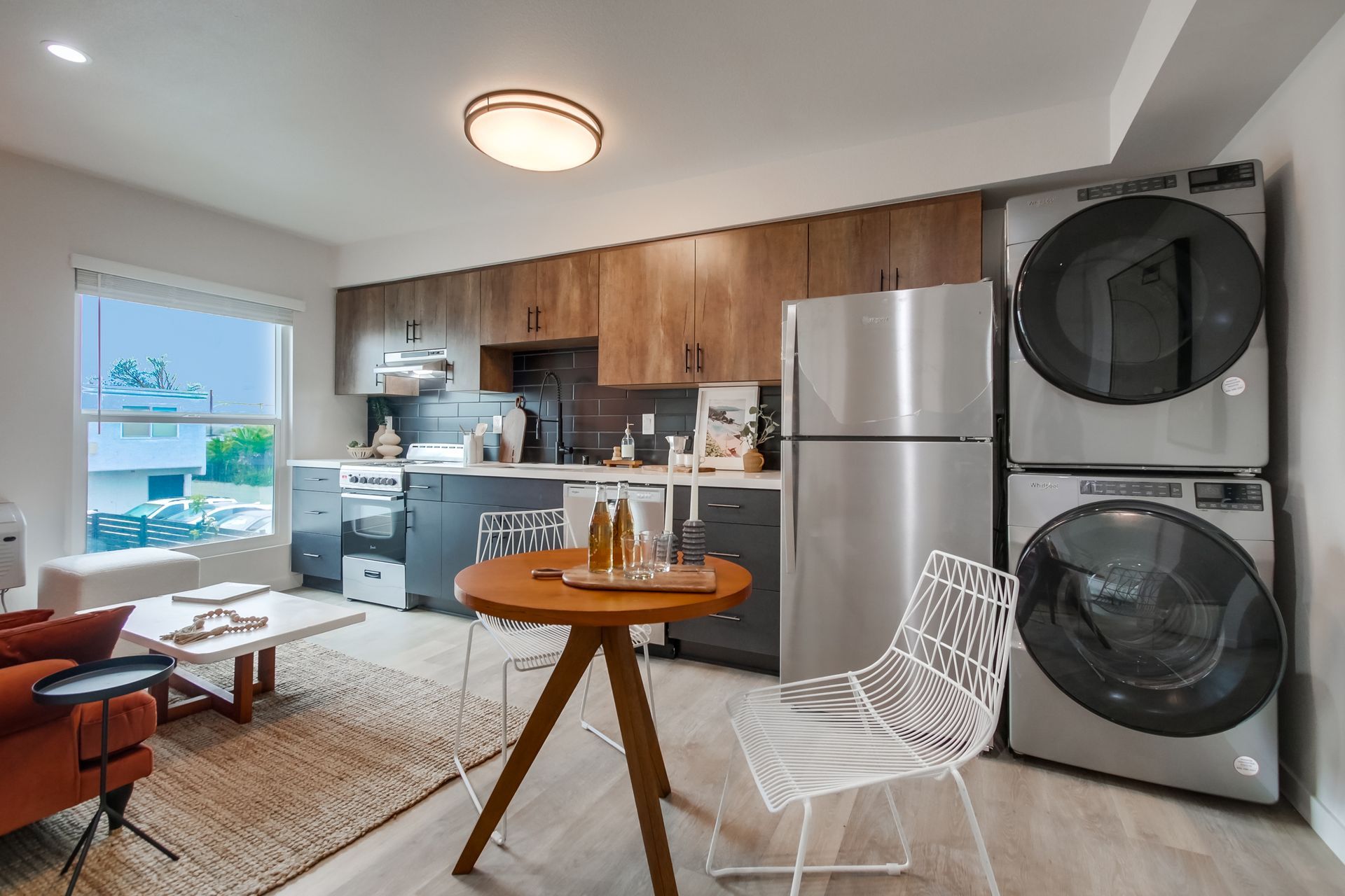 Photo showing a single row kitchen with a very wide window next to it