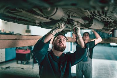 Two Mechanics Repairing Exhaust System — Huntsville, AL — Worth Exhaust Center