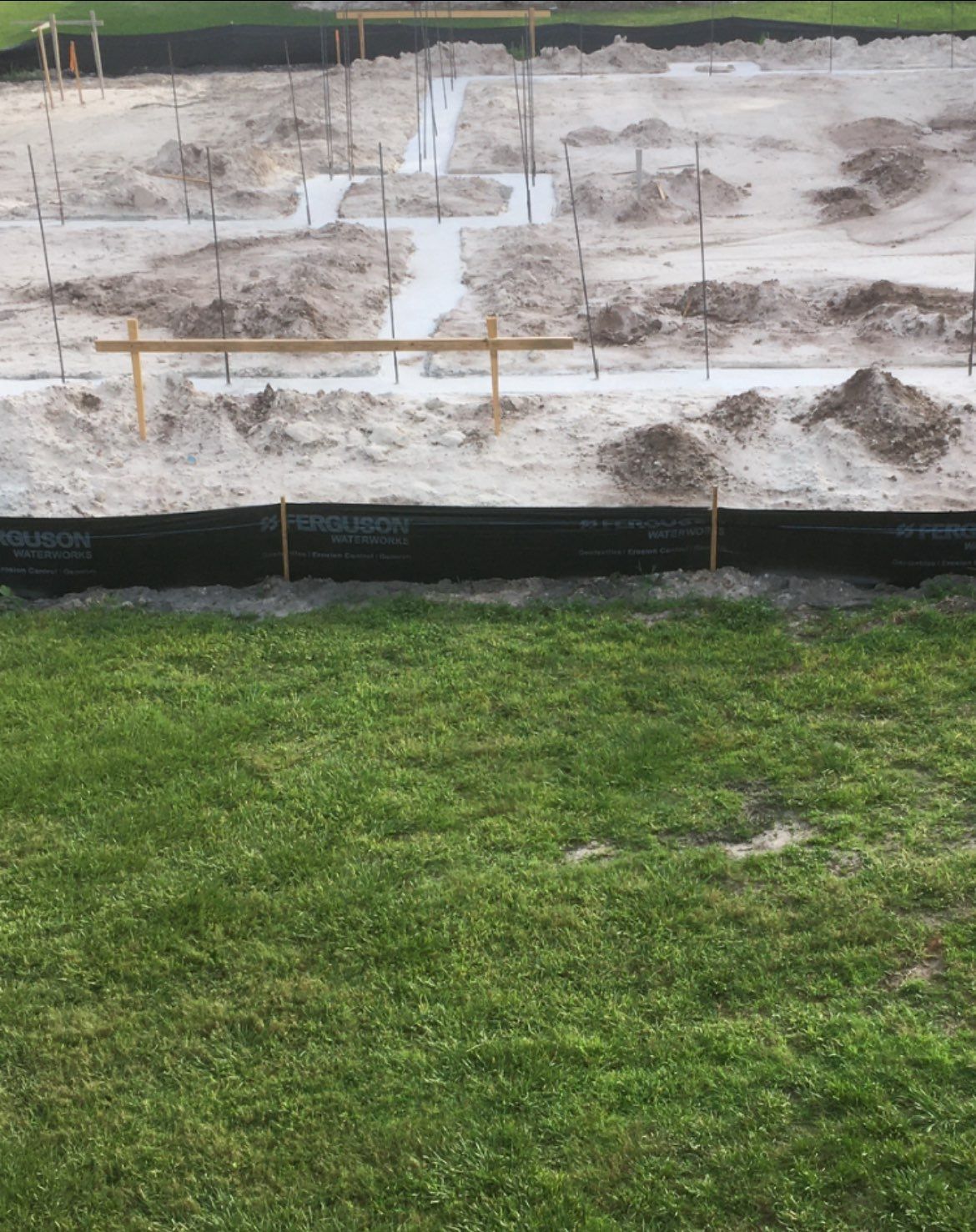 A construction site with a lot of dirt and grass.