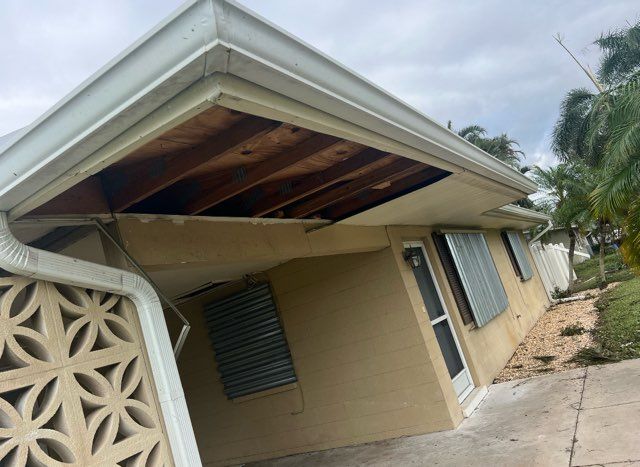 A house with a roof that has been damaged by a storm
