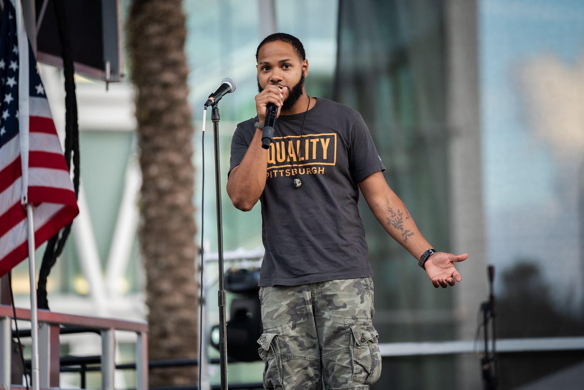 A man is standing in front of a microphone.