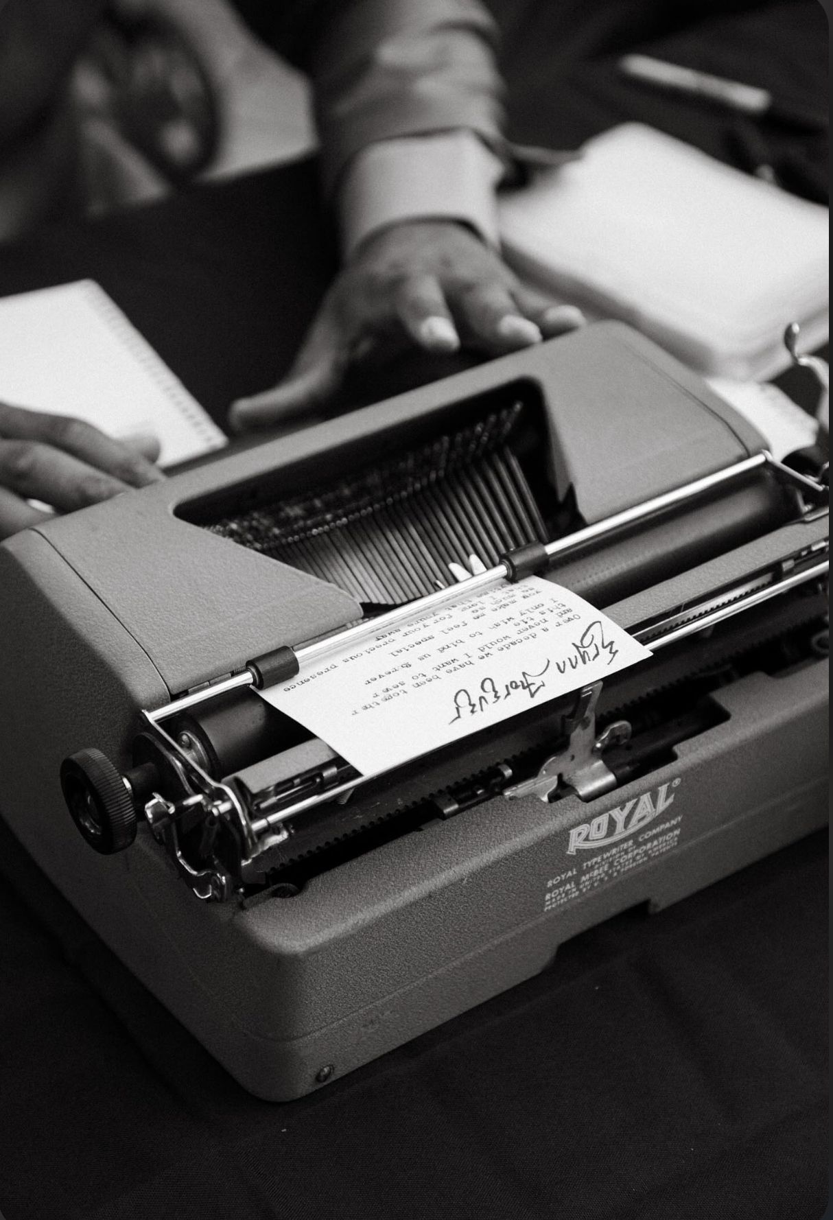 A person is typing on a royal typewriter