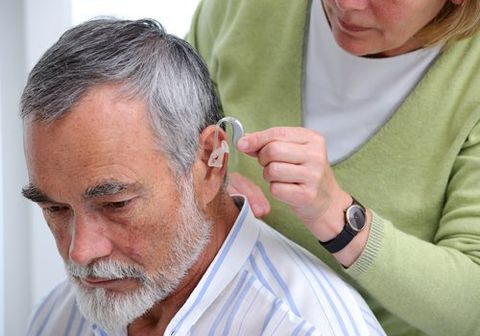 Hearing Loss — Person Adjusting Hearing Aid in Cape May Court House, NJ