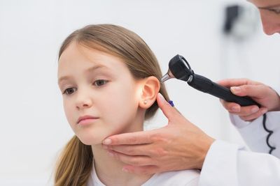 Hearing Aids — Young Girl Having Ear Examined by Doctor in Cape May Court House, NJ