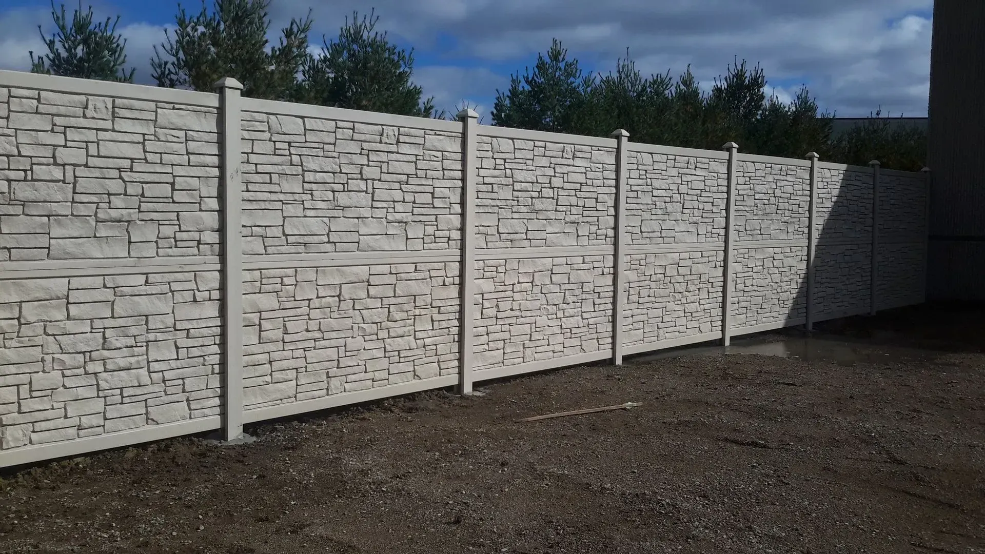 A white fence with a maze pattern on it