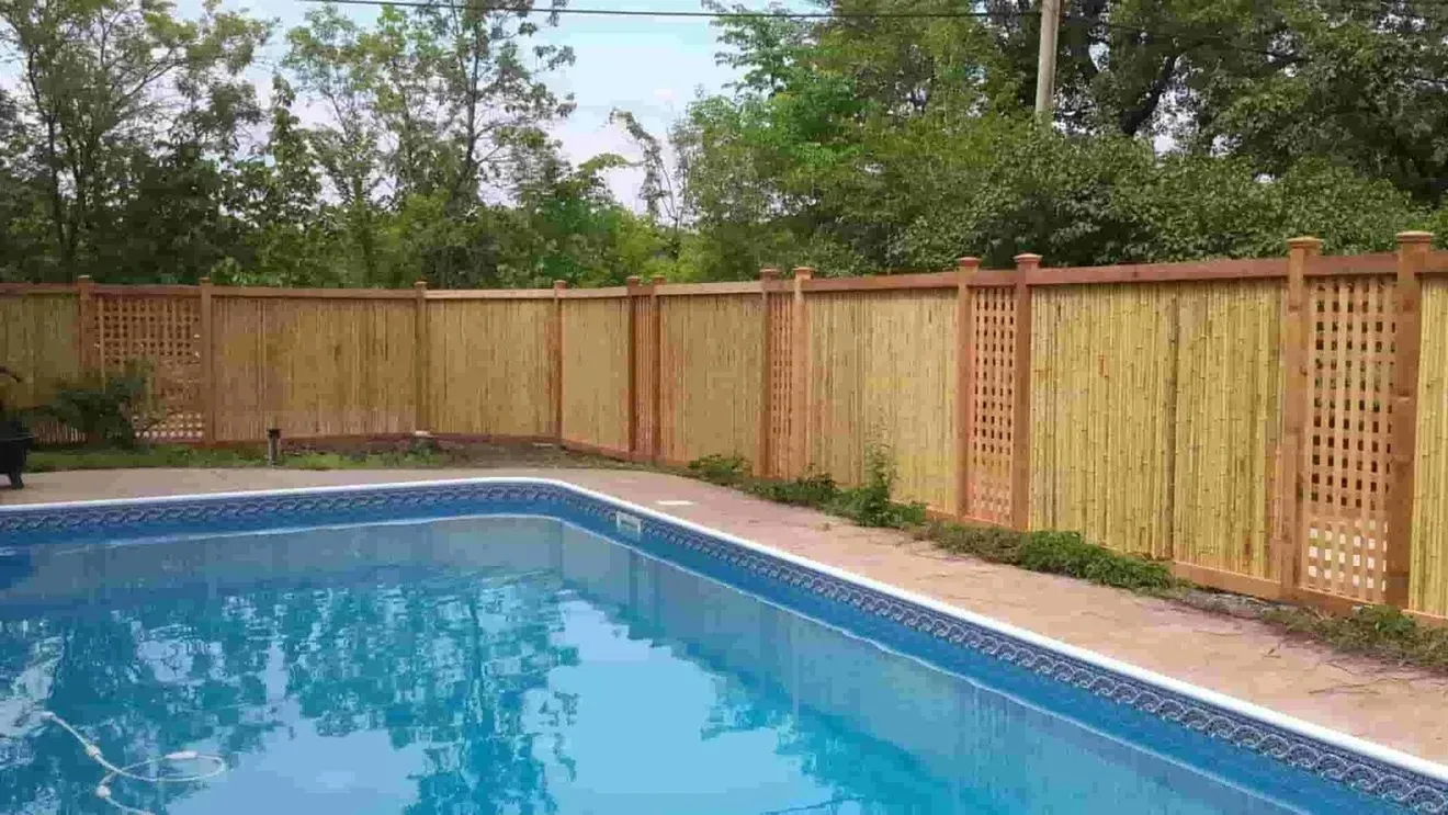 Rooftop cooling system with safety railings on a flat, gravel-covered roof against a cloudy sky.
