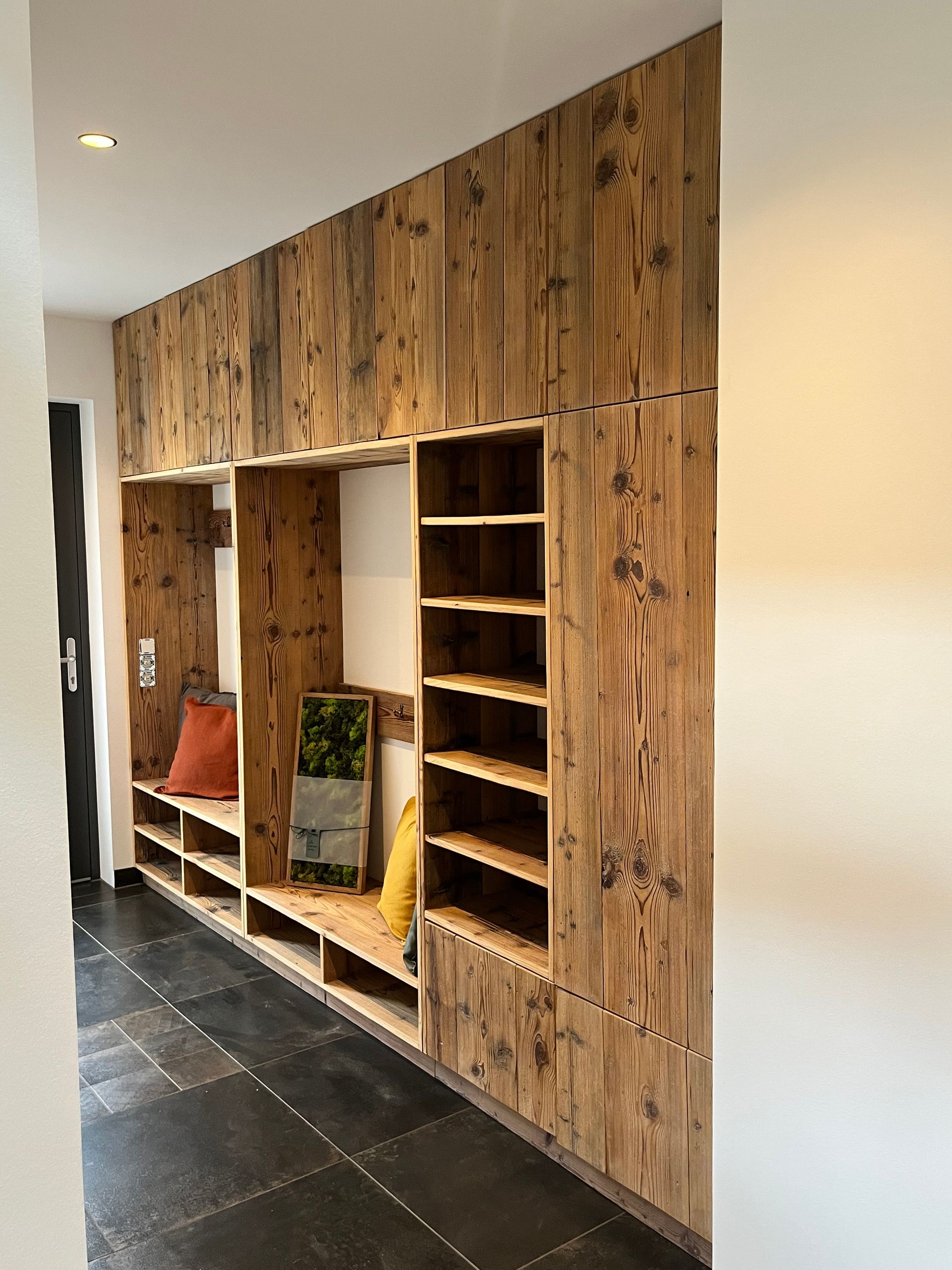 Garderobe mit Sitzplatz aus Altholz Kiefer, geschlossenen Fronten und offenen Fächern.