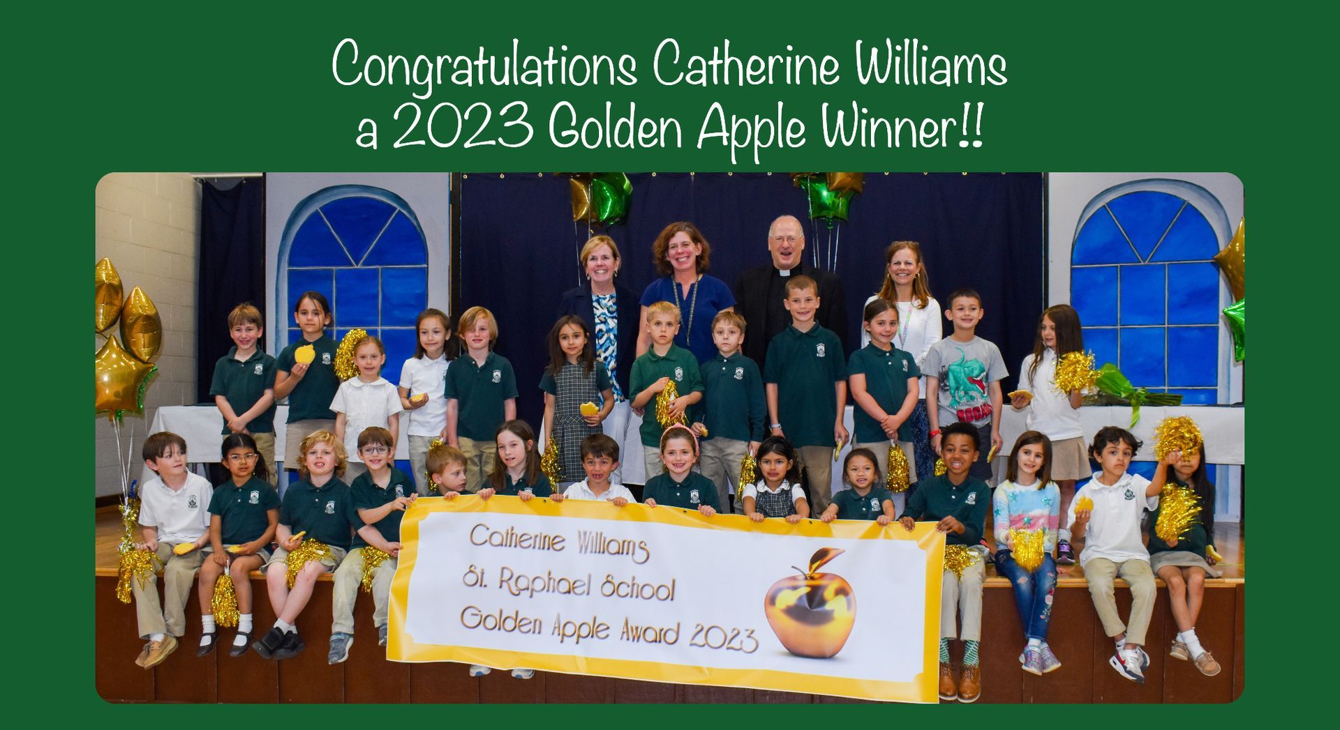 A group of children holding a sign that says golden apple winner