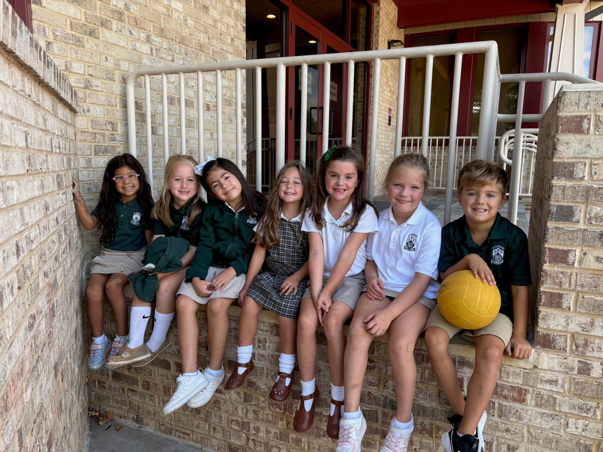 A woman stands in front of a blue ribbon award winner banner