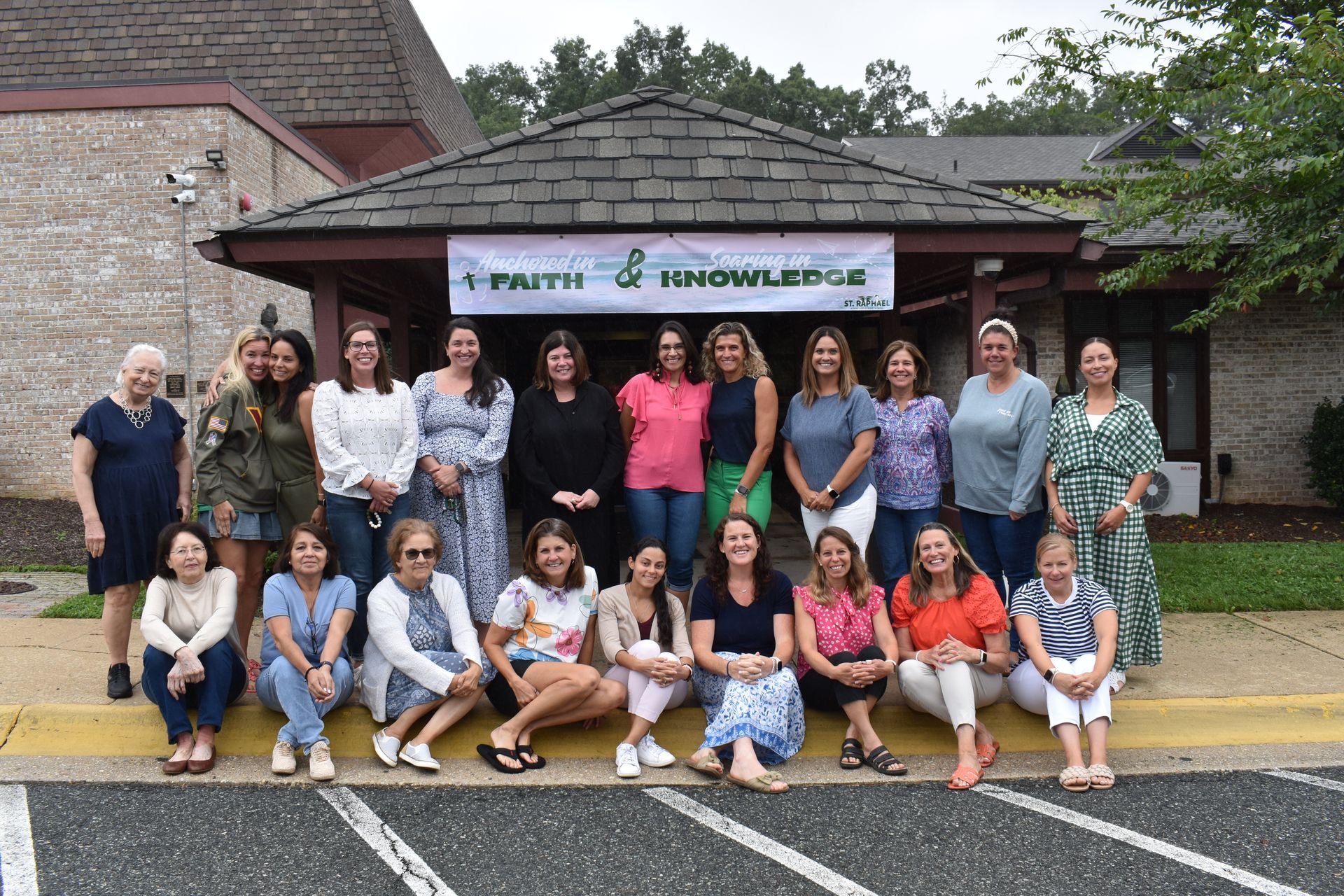 A woman is kneeling down in front of a group of children
