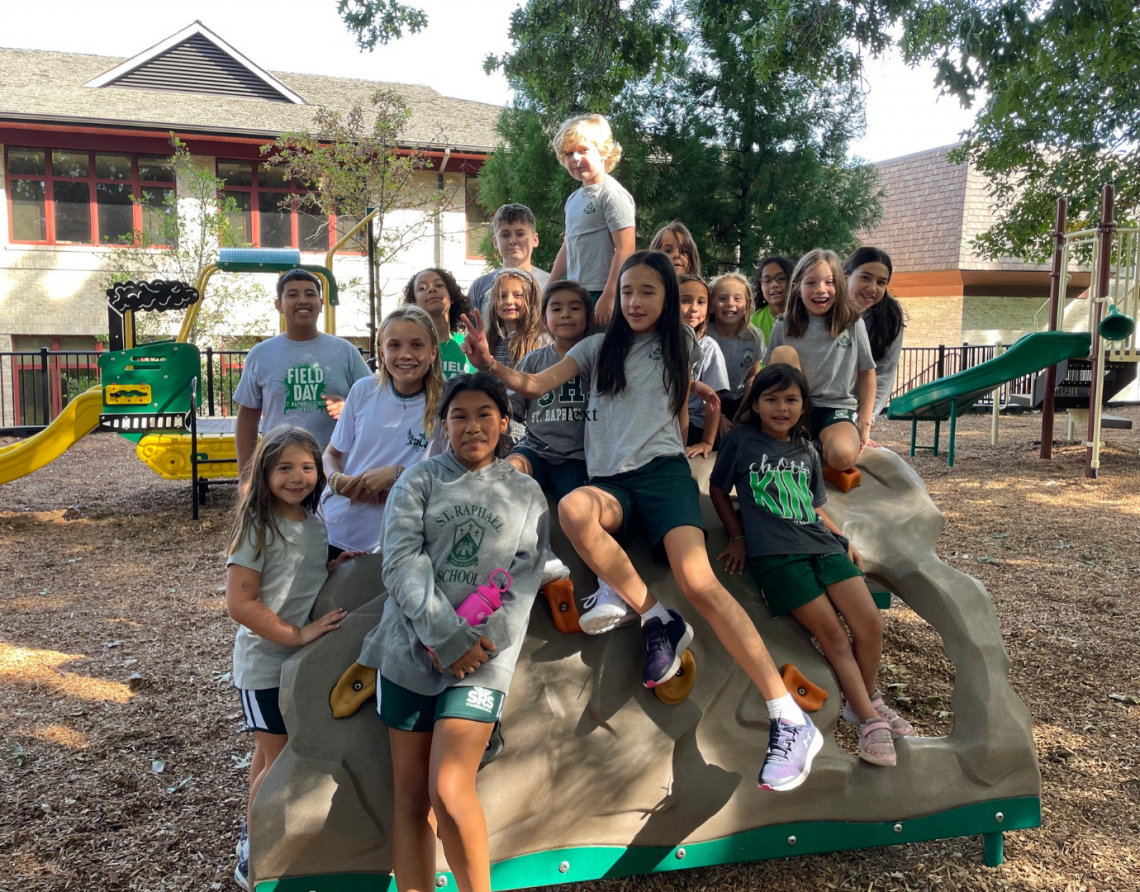 A group of children are posing for a picture at a playground