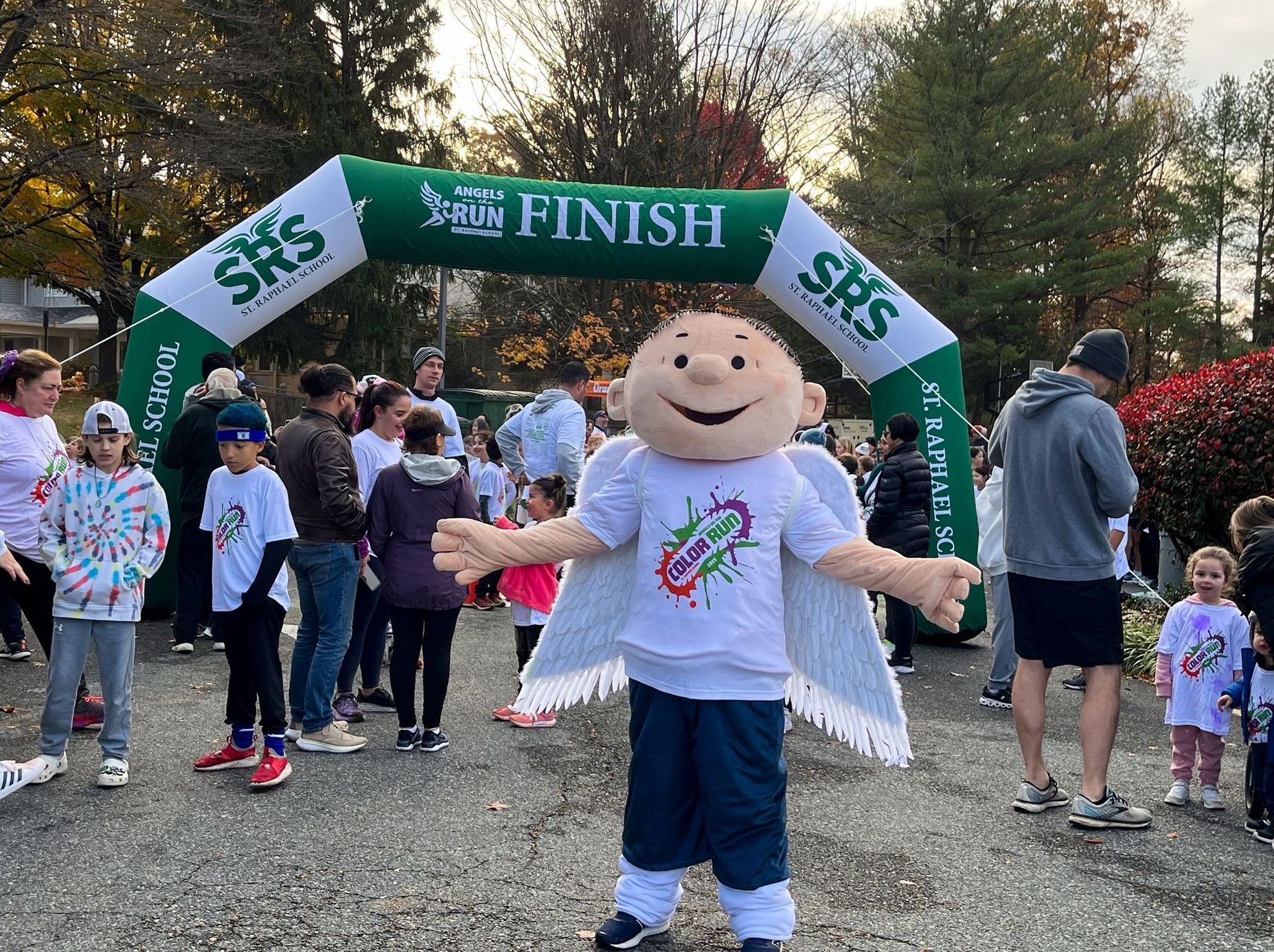 A group of children are running under a banner that says run finish