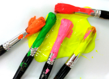 A bunch of paint brushes with different colors on them