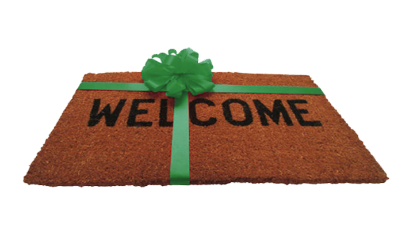 A welcome mat with a green bow on it