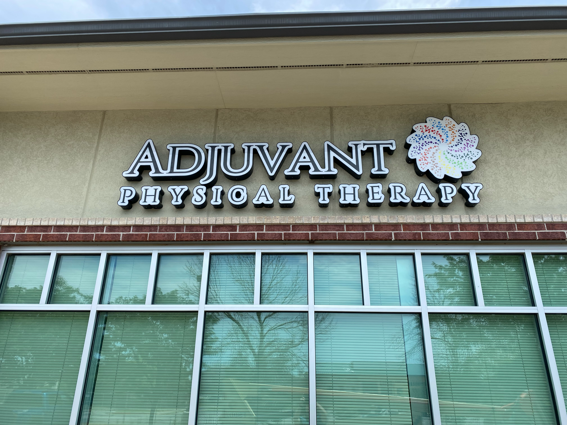 A building with a sign that says adjuvant physical therapy