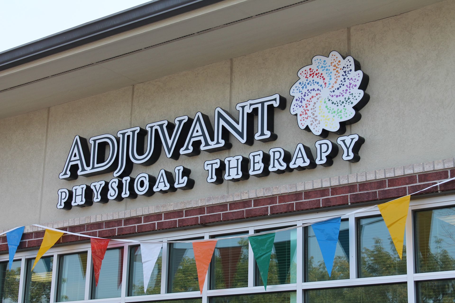 A building with a sign that says adjuvant physical therapy