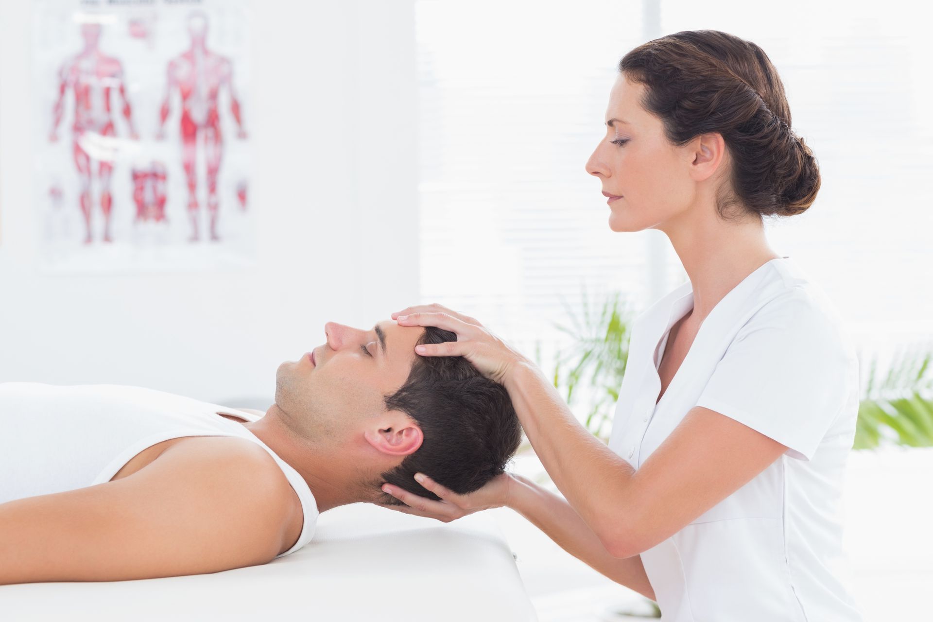 A woman is giving a man a head massage.