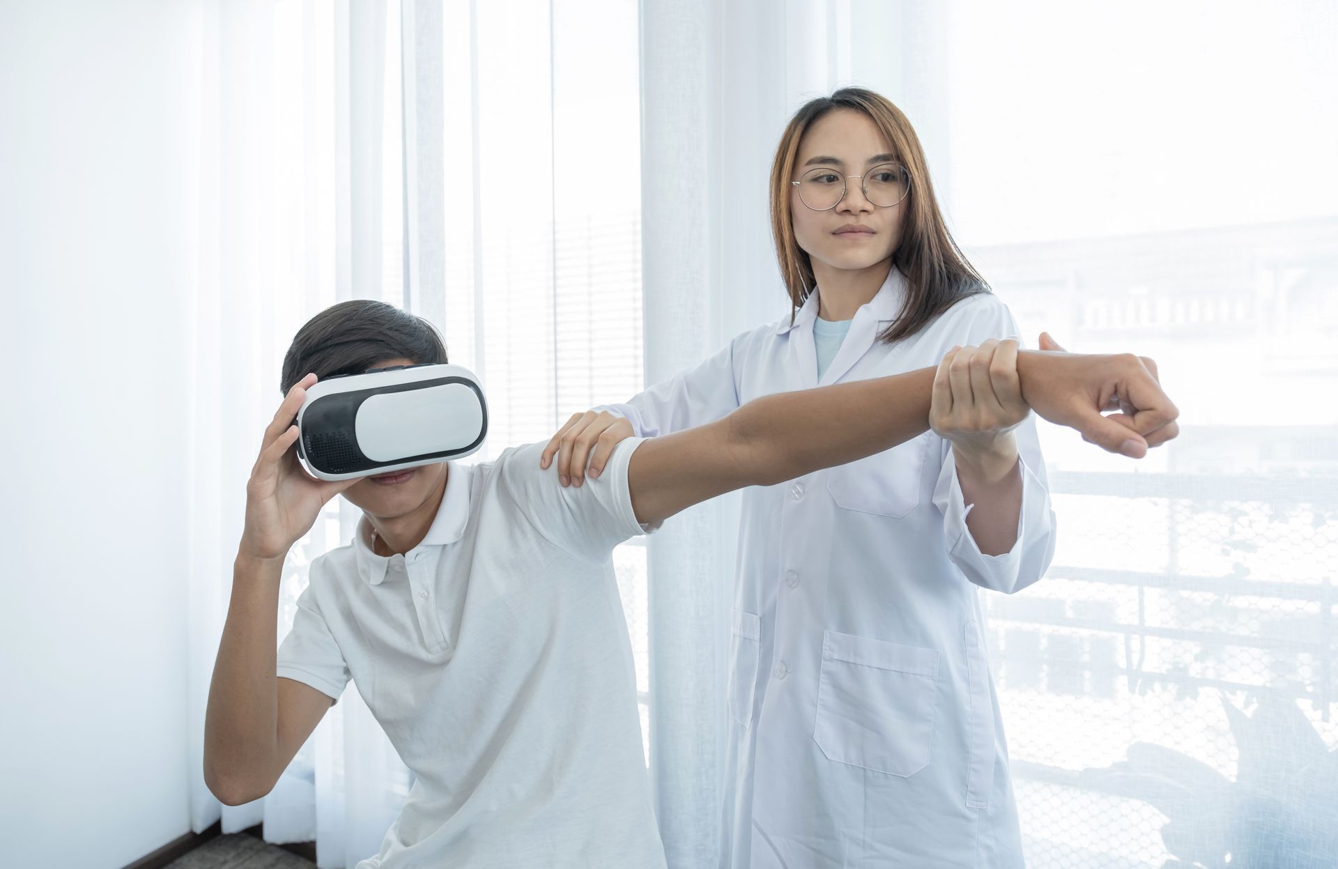 A man wearing a virtual reality headset is being examined by a doctor.