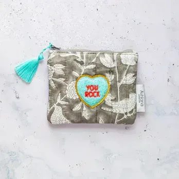 A purse with a heart embroidered on it that says `` you rock ''.