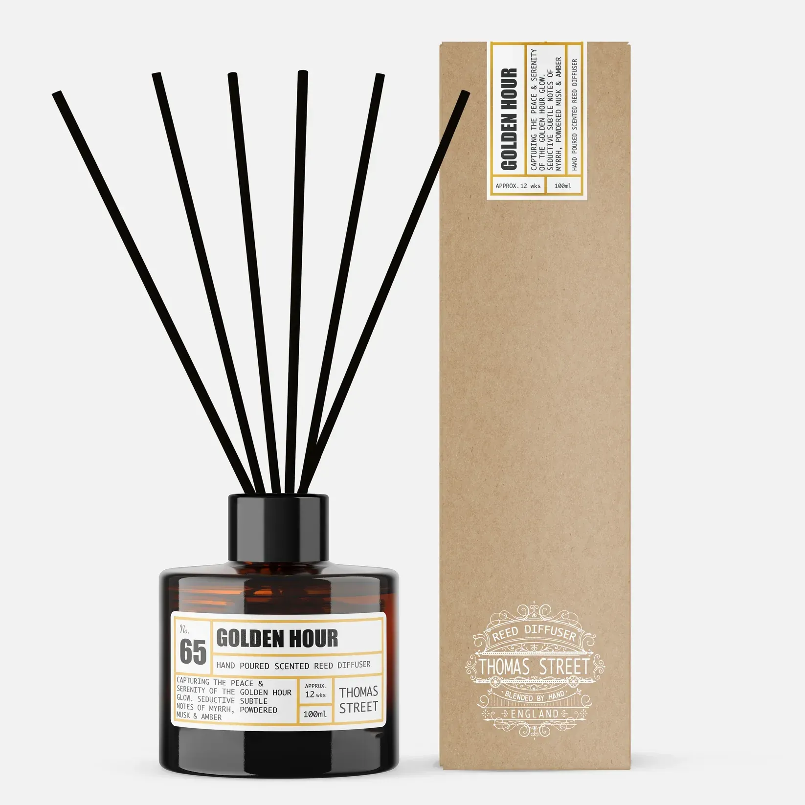 A bottle of golden hour reed diffuser next to a box
