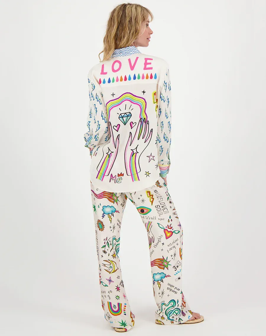 A woman wearing a white shirt with the word love on it