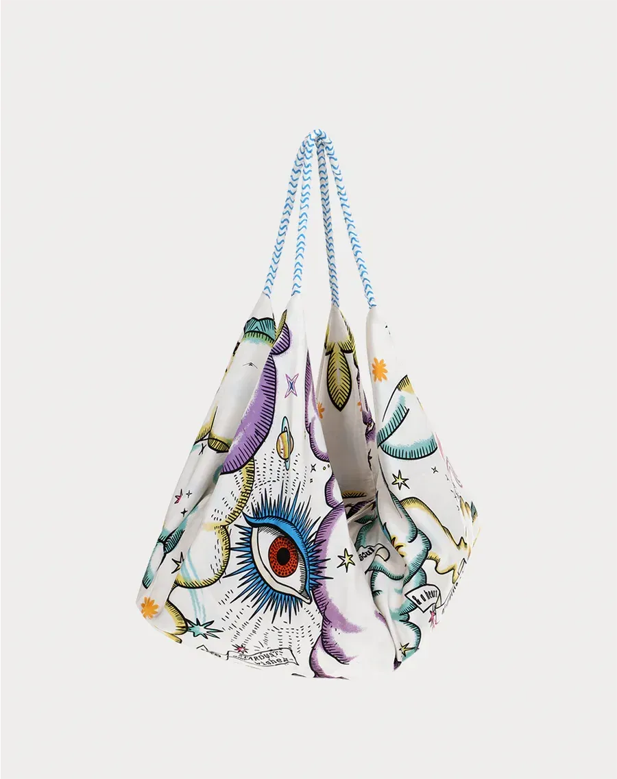 A white bag with a colorful eye on it