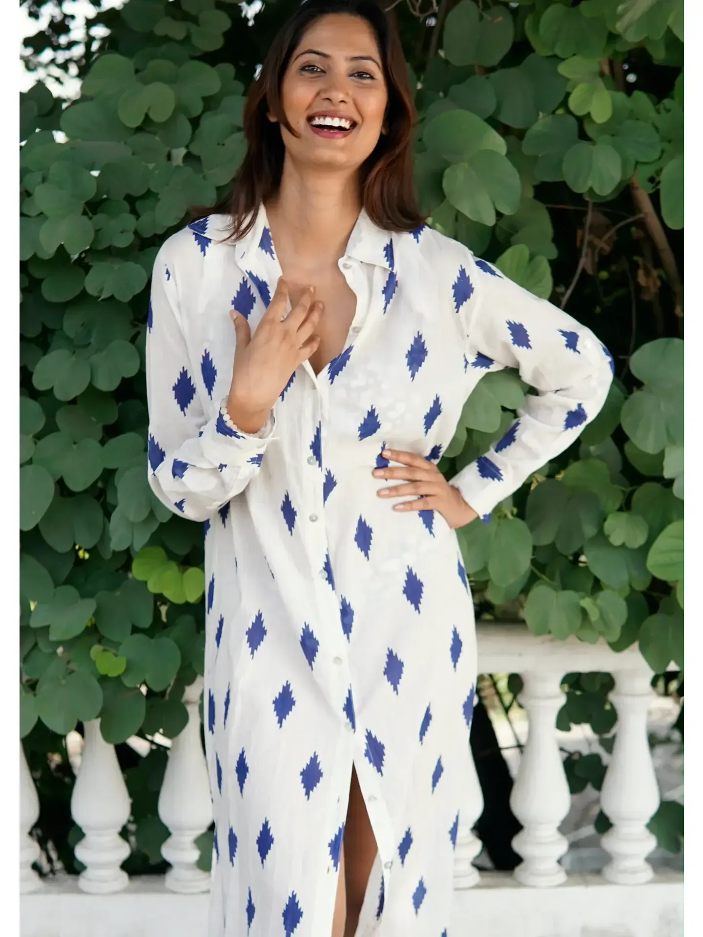 A woman wearing a white dress with blue diamonds on it