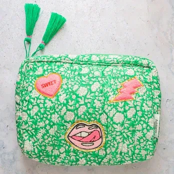 A green purse with a pink heart that says sweet on it