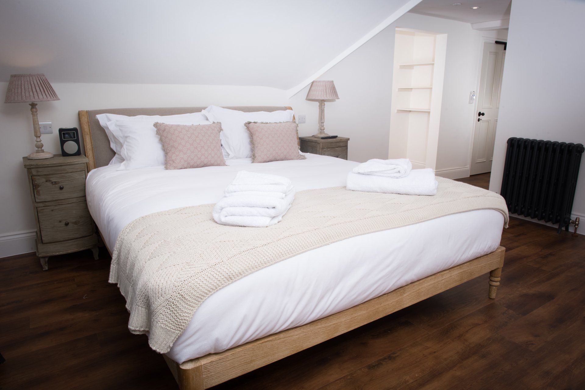 A bedroom with a king size bed and two nightstands