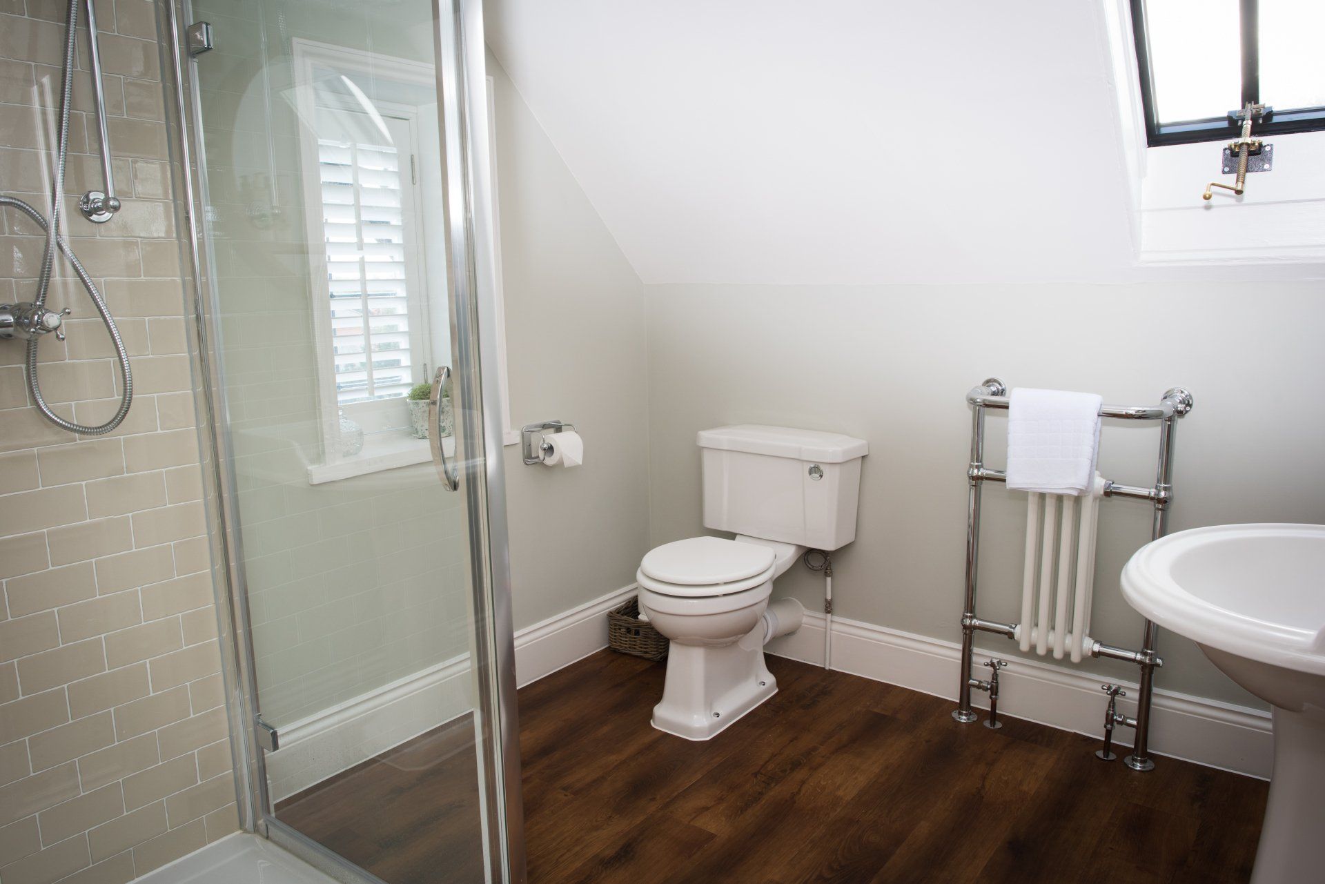 A bathroom with a toilet , sink , and shower.