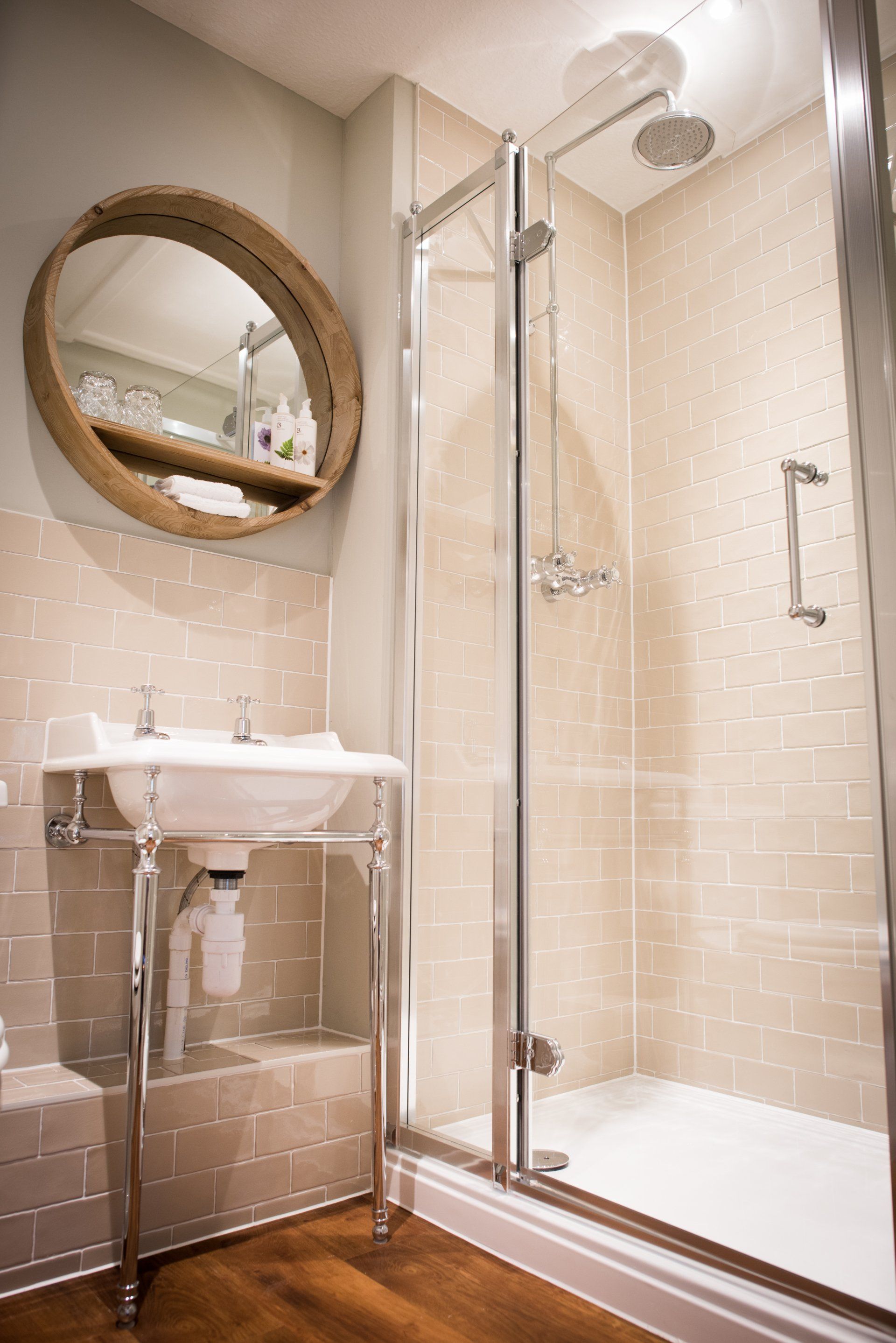 A bathroom with a sink and a walk in shower.
