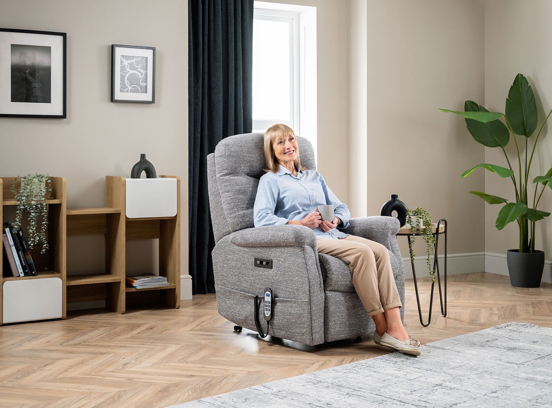 Woman sitting in a gray lift recliner
