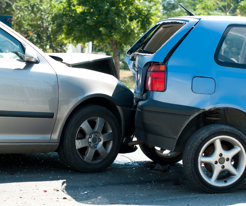 A silver car and a blue car are involved in a car accident