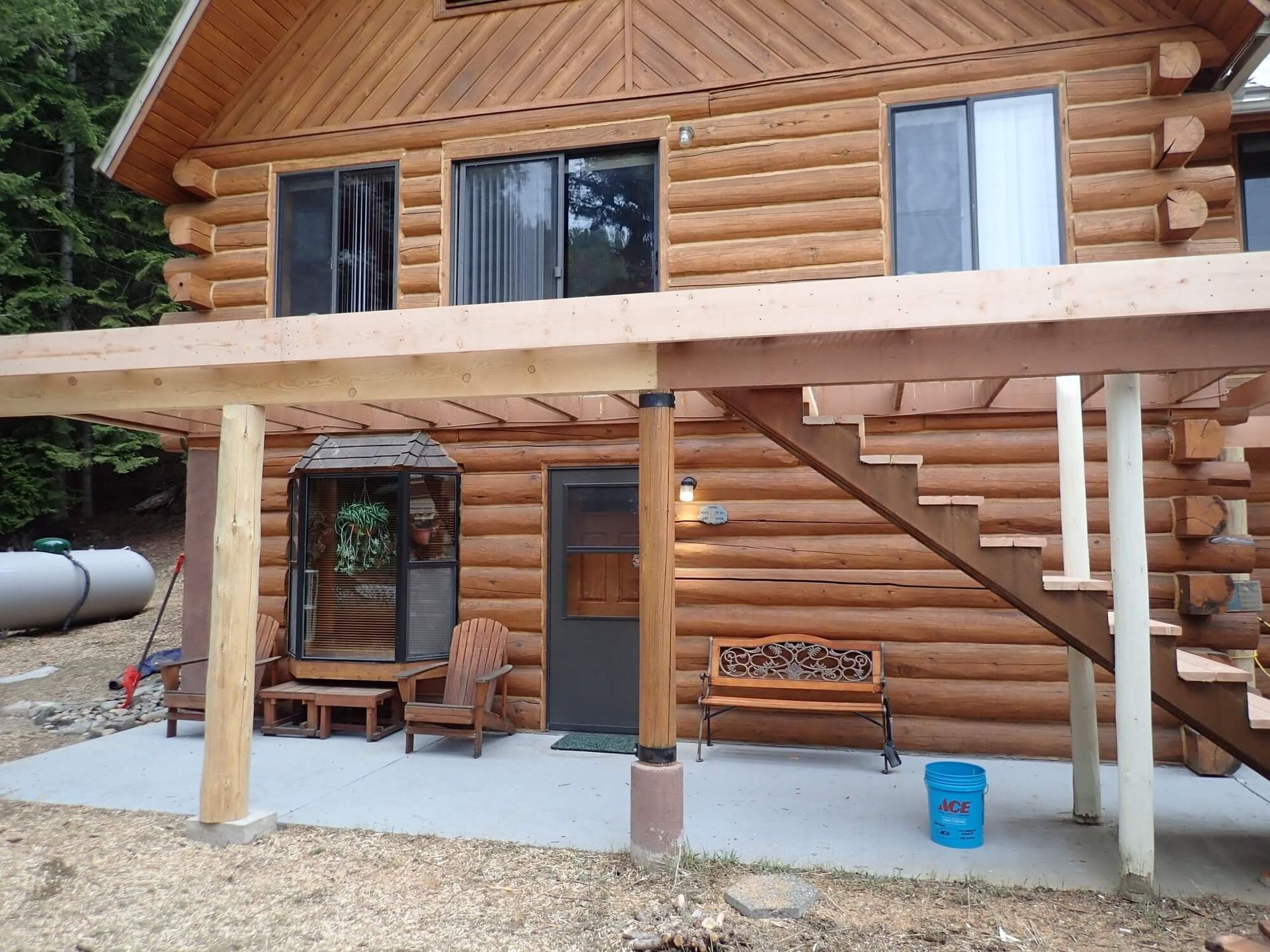 A log cabin with stairs leading up to the second floor