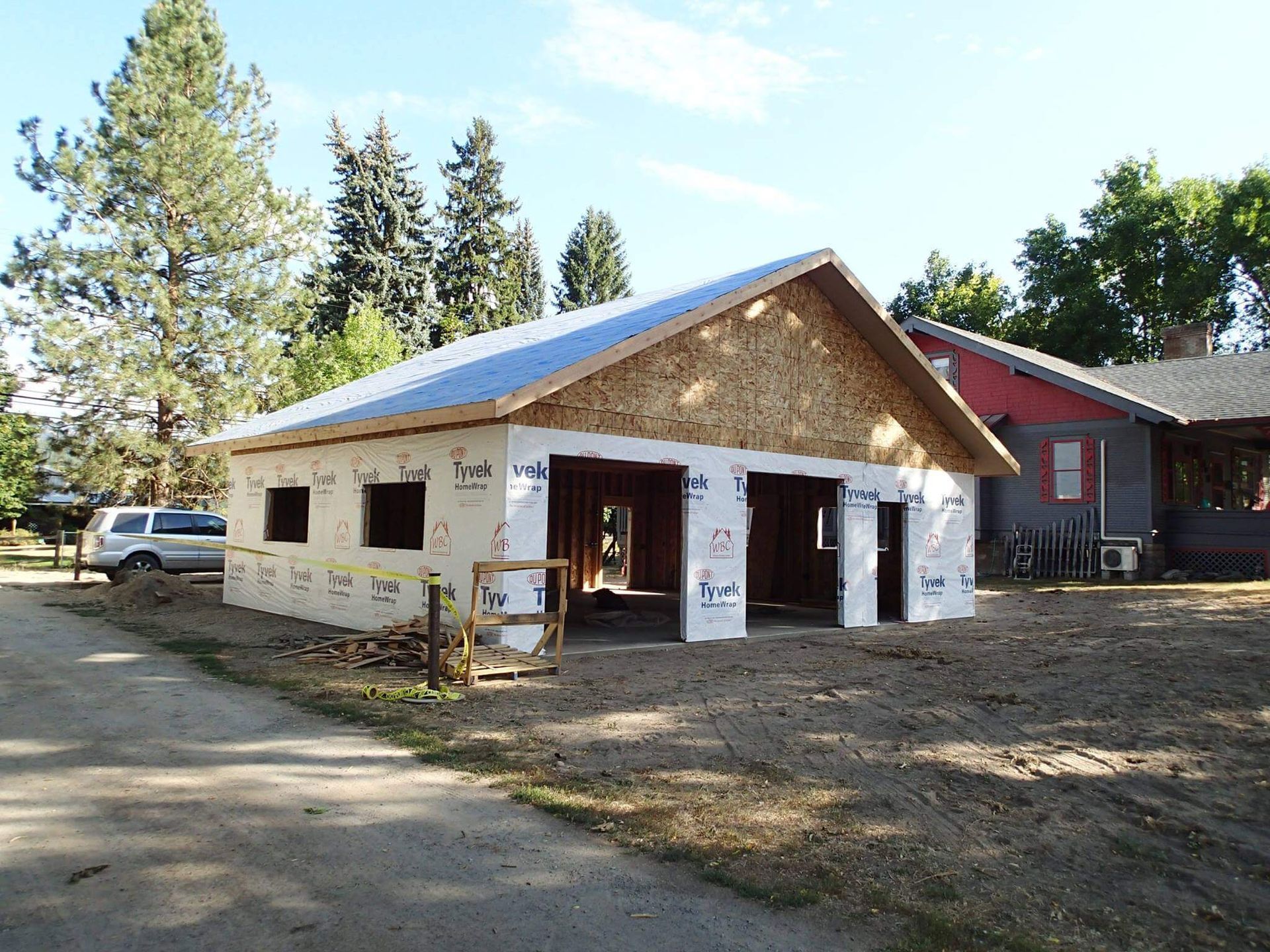 A garage is being built next to a house