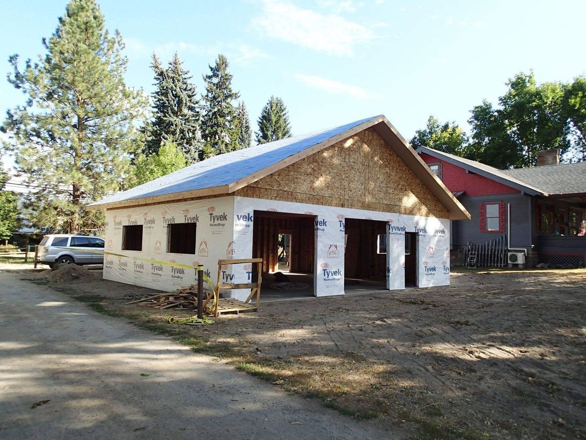 A red building with a green roof is surrounded by snow