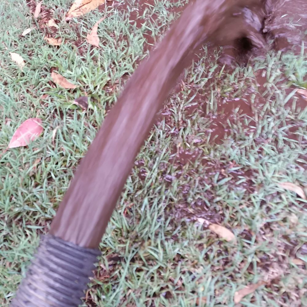 A Close Up of a Hammer in the Grass — Tink's Water Tank Cleaning in Harrington, NSW
