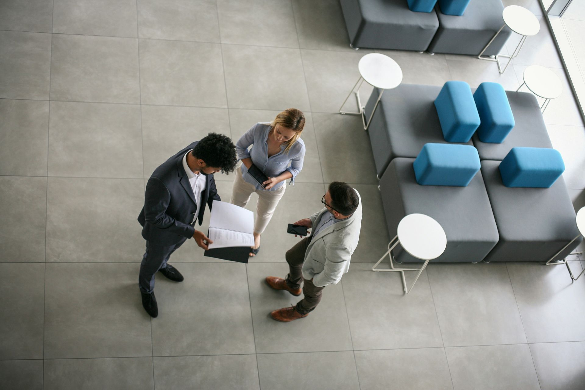 Person using laptop, hands on trackpad, another laptop on table.