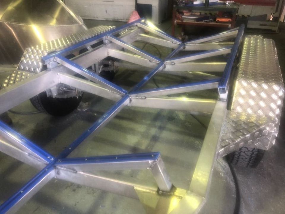 A metal structure is being built in a garage.