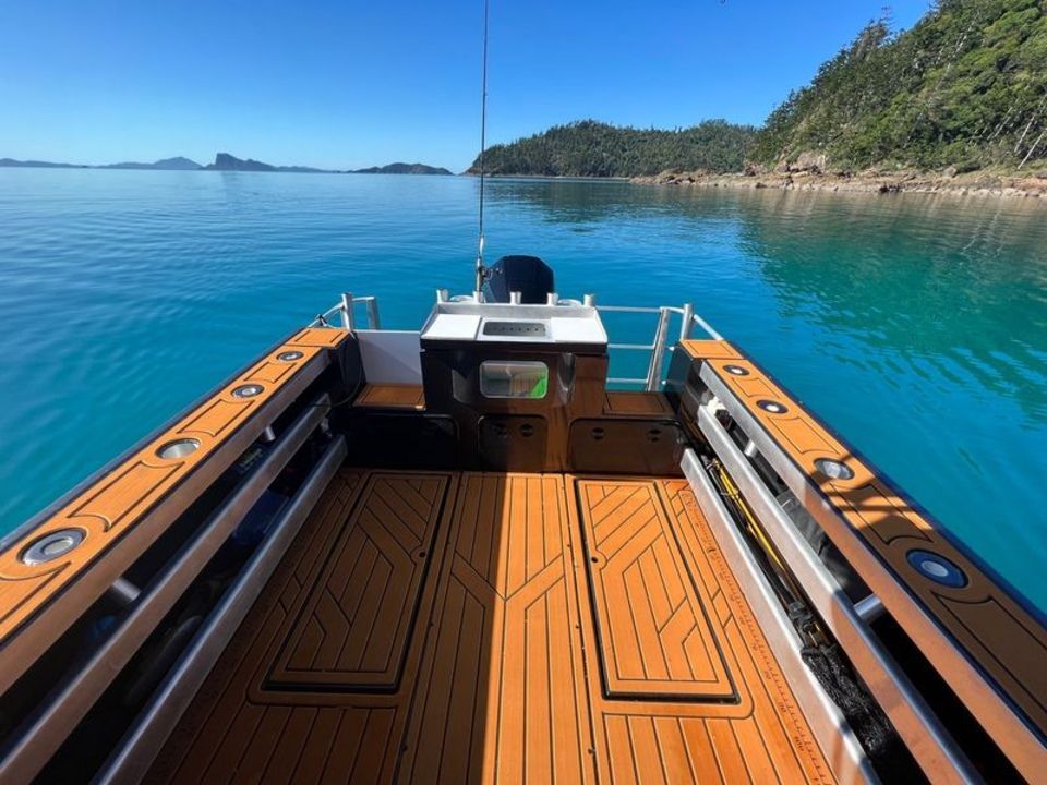 A boat with a wooden deck is in the water