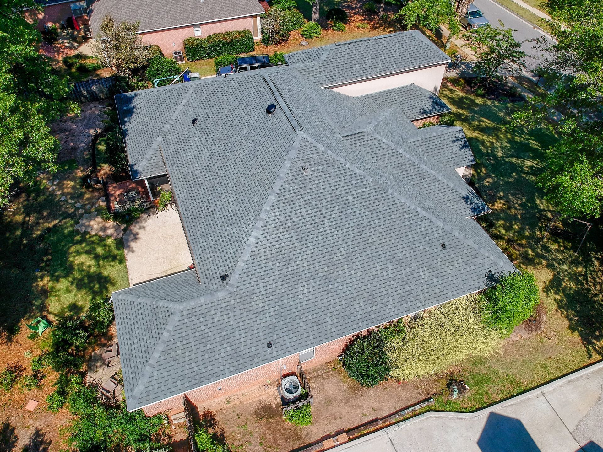 An aerial view of a house with a gray roof