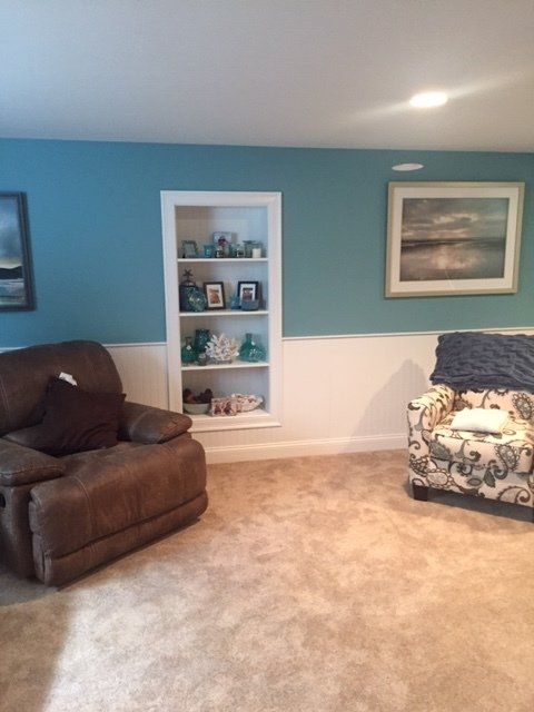 basement with furniture and blue walls