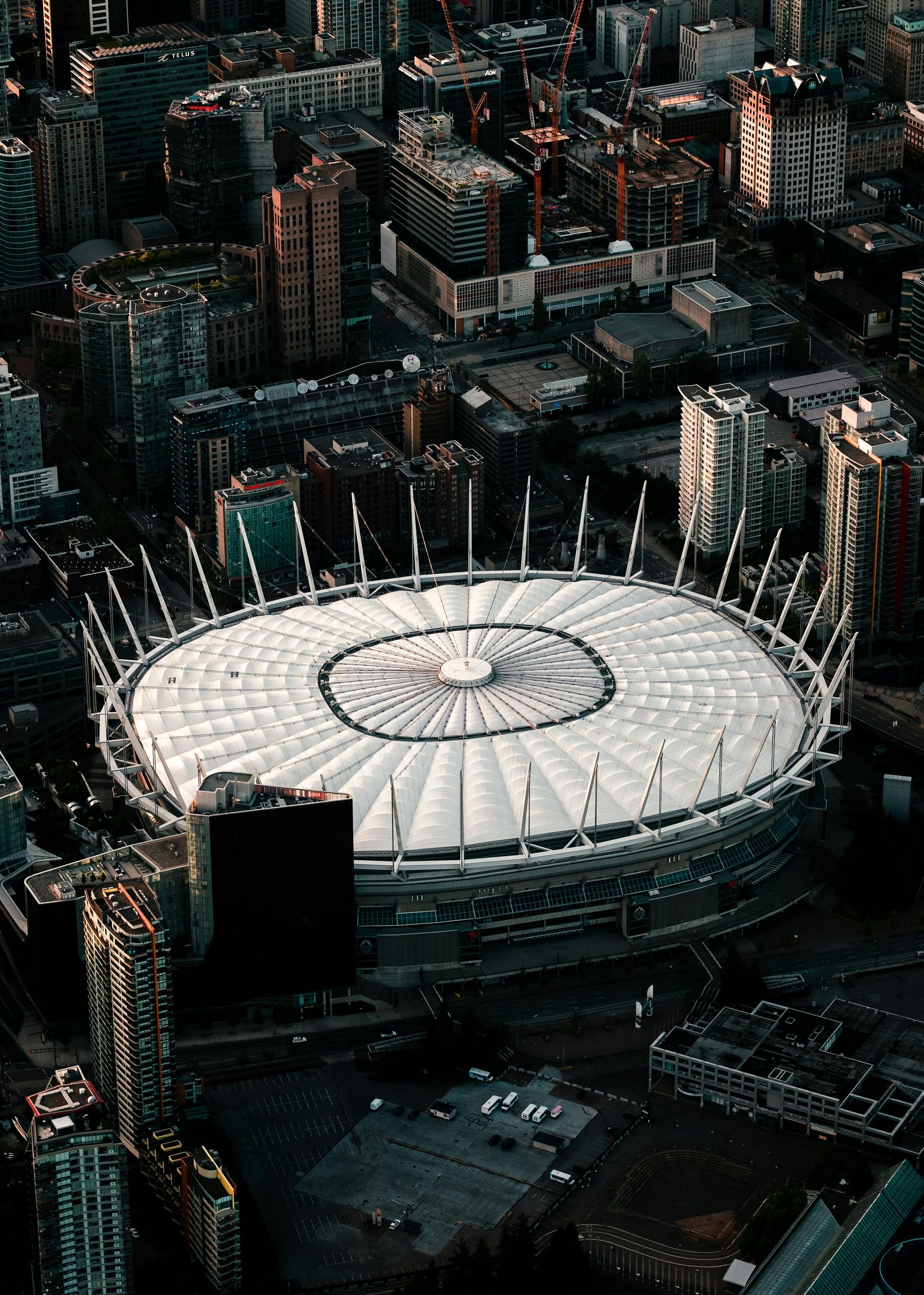 An aerial view of a large stadium in the middle of a city.