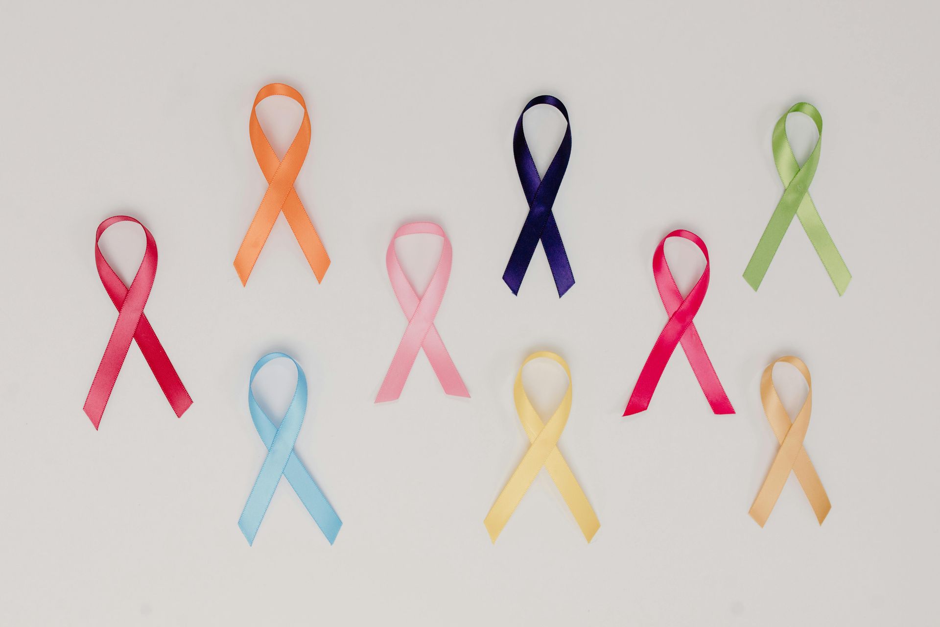 A bunch of different colored ribbons on a white background